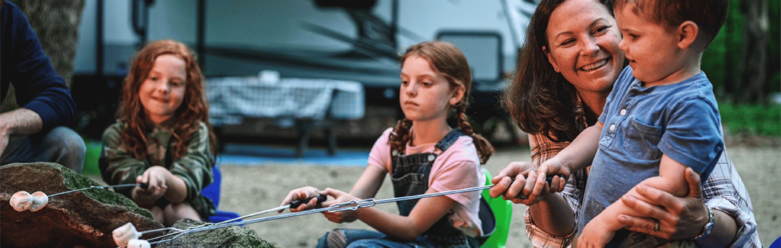 Family camping in front of their RV